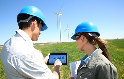 workers_looking_at_tablet_near_windmillsmall.jpg